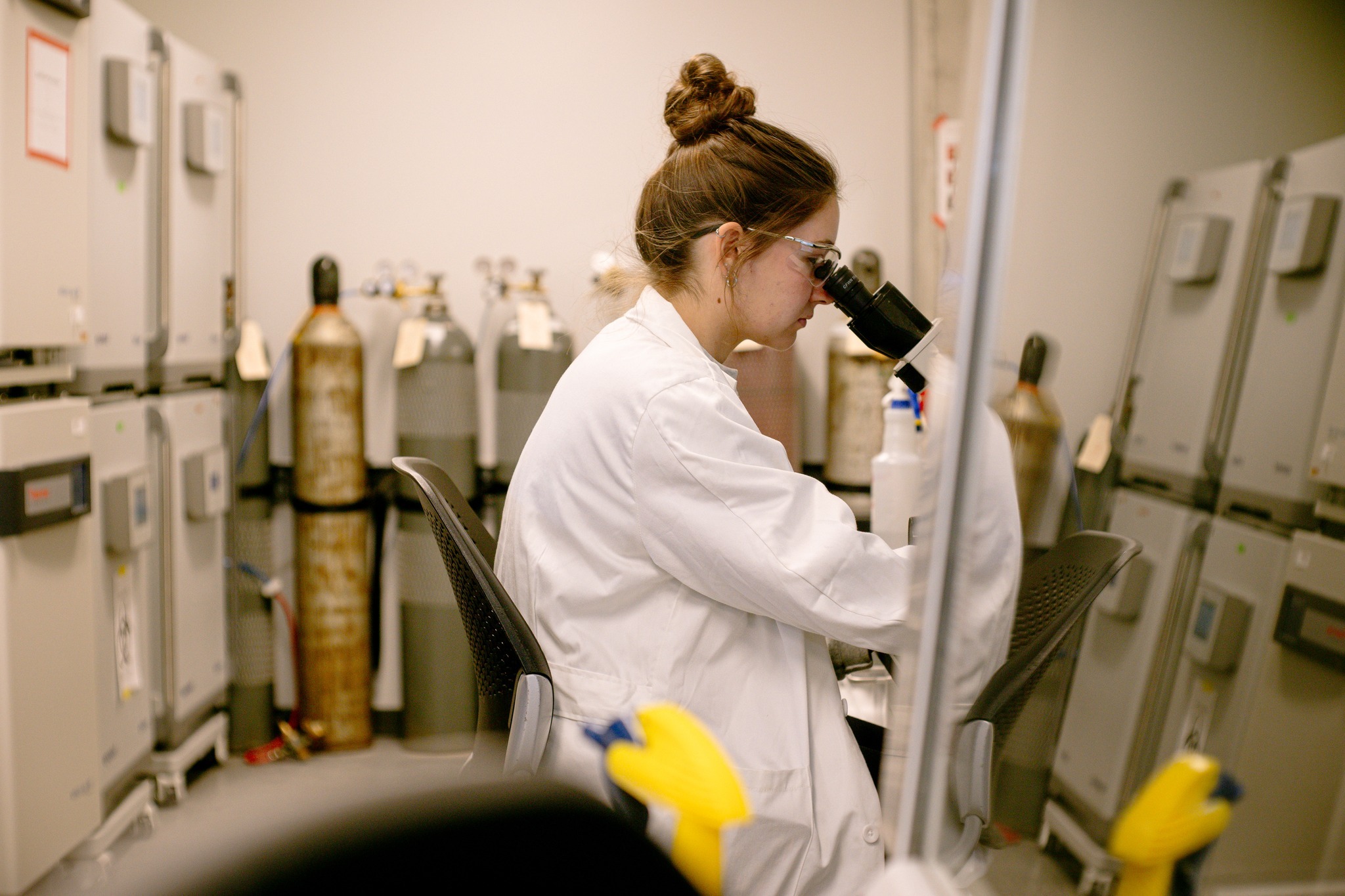 Student looking through a microscope