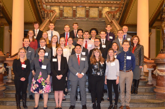 Group photo of undergraduate research students on the interior steps of the Iowa Capitol building.